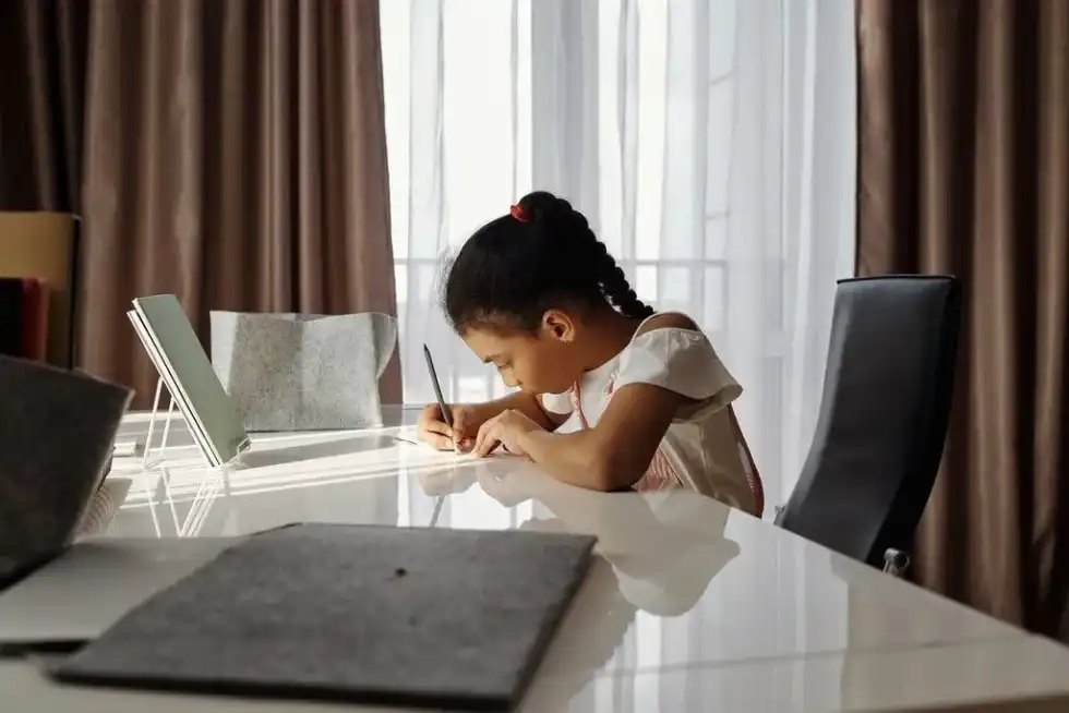 Young girl sat at her desk studying the WW2 timeline.