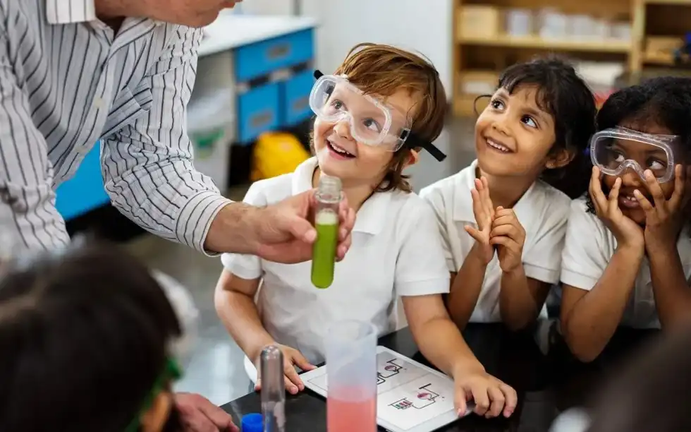 Young kids in science class being shown experiments to learn about states of matter.