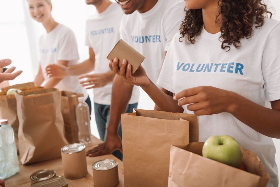 Young volunteers group packing food and drinks for charity.