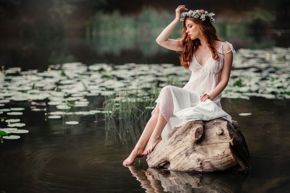 Young woman in white Greek style dress and tiara